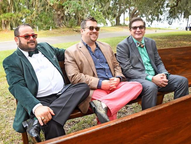 Staff wearing sunglasses sitting on a park bench